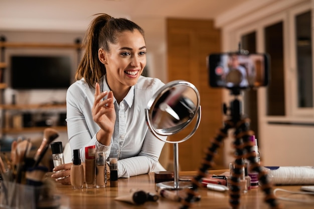 [freepicdownloader.com]-smiling-female-influencer-talking-about-beauty-products-while-vlogging-from-home-normal